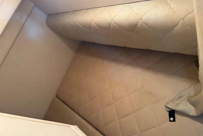 Slide: The Image of Interior cabin of 2006 Sea Ray 260 Sundancer with beige quilted upholstery. - 35