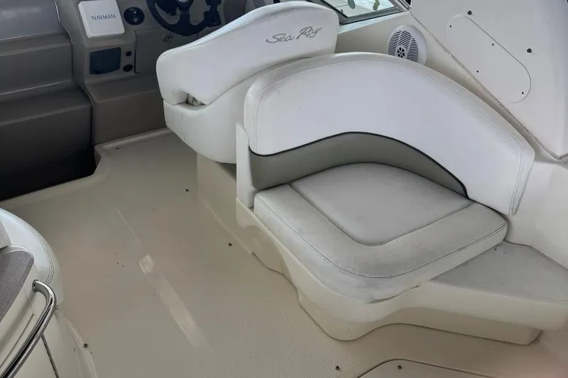 Slide: The Image of 2006 Sea Ray 260 Sundancer interior with white seating and helm area. - 8