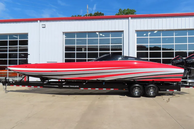 The Image of Red 2021 Wright Performance 360 Carbon speedboat on trailer, parked outside a garage. - 0