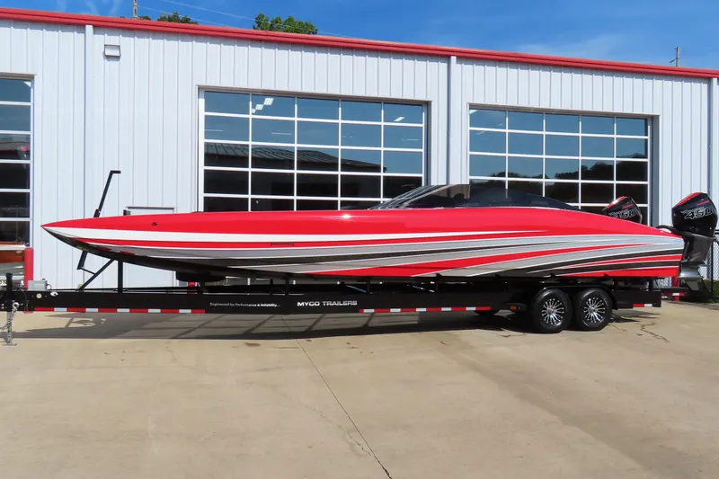 Slide: The Image of 2021 Wright Performance 360 Carbon speedboat on trailer, red and silver design, parked outside. - 1