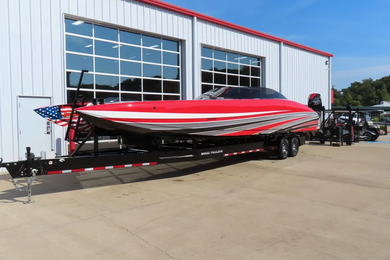 Slide: The Image of Red 2021 Wright Performance 360 Carbon boat on trailer outside a garage. - 2