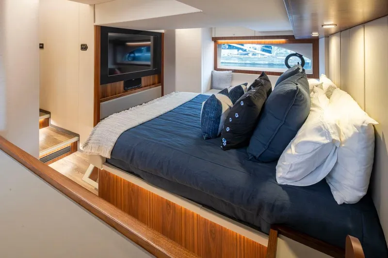 Slide: The Image of Luxurious interior of 2023 Riviera 505 SUV yacht with cozy bed and modern decor. - 12