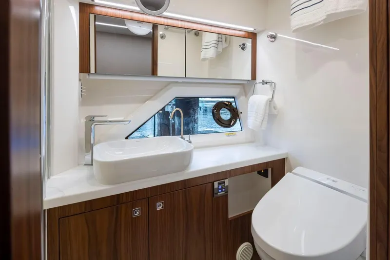 Slide: The Image of Luxurious bathroom in 2023 Riviera 505 SUV yacht with modern fixtures and elegant design. - 18