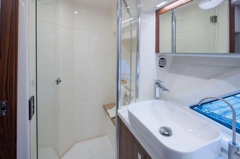 Slide: The Image of Luxurious bathroom in 2023 Riviera 505 SUV yacht with modern fixtures and glass shower. - 19