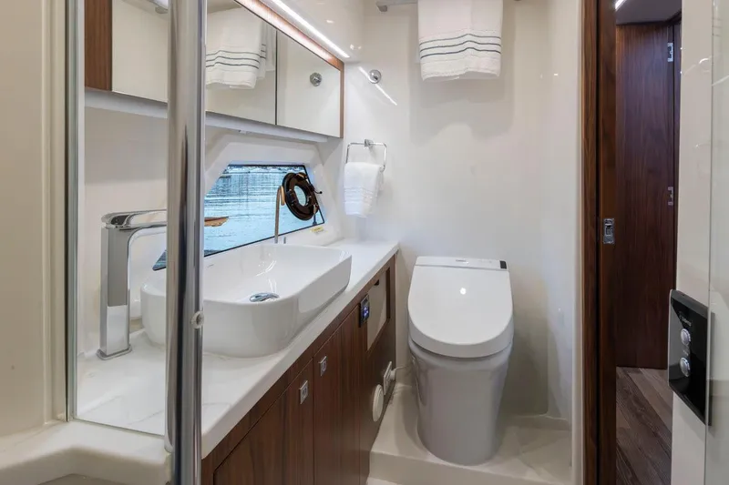 Slide: The Image of Luxurious bathroom in 2023 Riviera 505 SUV yacht with modern fixtures and elegant design. - 20