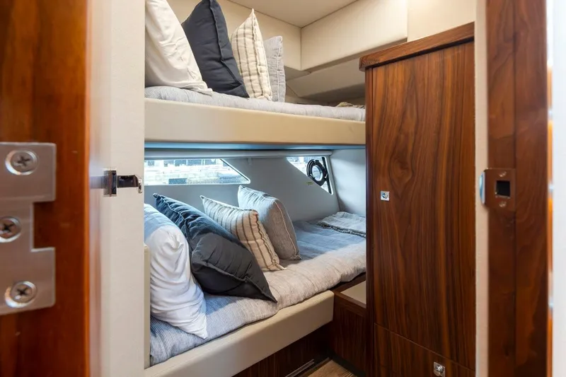 Slide: The Image of 2023 Riviera 505 SUV interior with cozy bunk beds and elegant wood finish. - 21