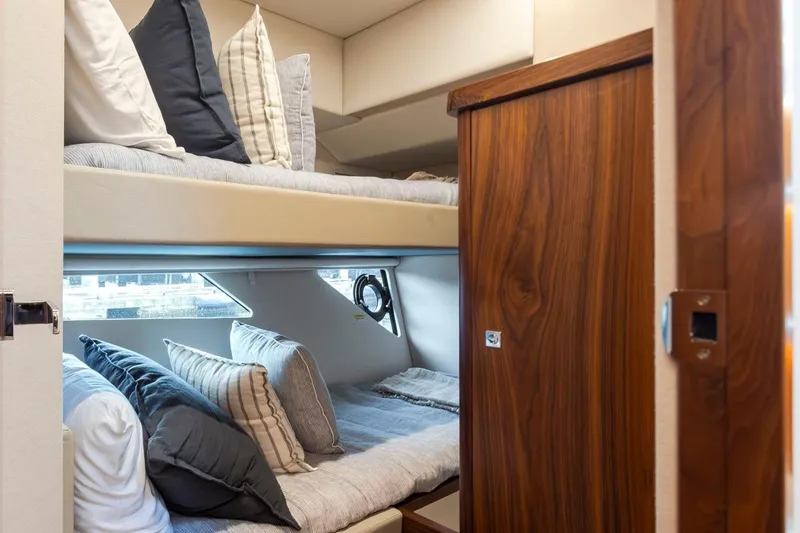 Slide: The Image of 2023 Riviera 505 SUV interior with cozy bunk beds and elegant wood finish. - 22