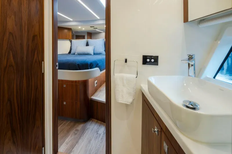 Slide: The Image of Luxurious interior of 2023 Riviera 505 SUV yacht, featuring a bedroom and modern bathroom. - 26