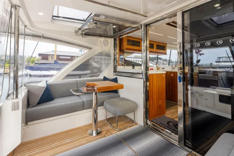 Slide: The Image of Luxurious interior of 2023 Riviera 505 SUV yacht with modern seating and wooden accents. - 32