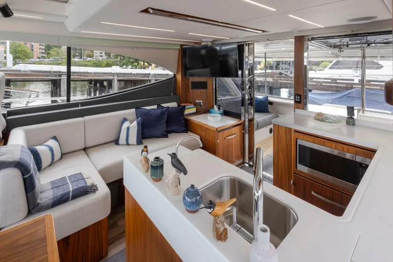 Slide: The Image of Luxurious interior of 2023 Riviera 505 SUV yacht with modern kitchen and comfortable seating. - 40