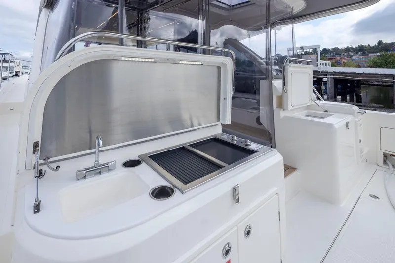 Slide: The Image of Outdoor kitchen on 2023 Riviera 505 SUV yacht with sink and grill. - 42