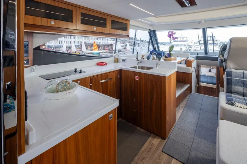Slide: The Image of Luxurious interior of 2023 Riviera 505 SUV yacht with modern kitchen and seating area. - 5