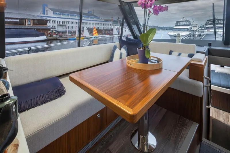 Slide: The Image of Luxurious interior of 2023 Riviera 505 SUV yacht with elegant wooden table and waterfront view. - 6