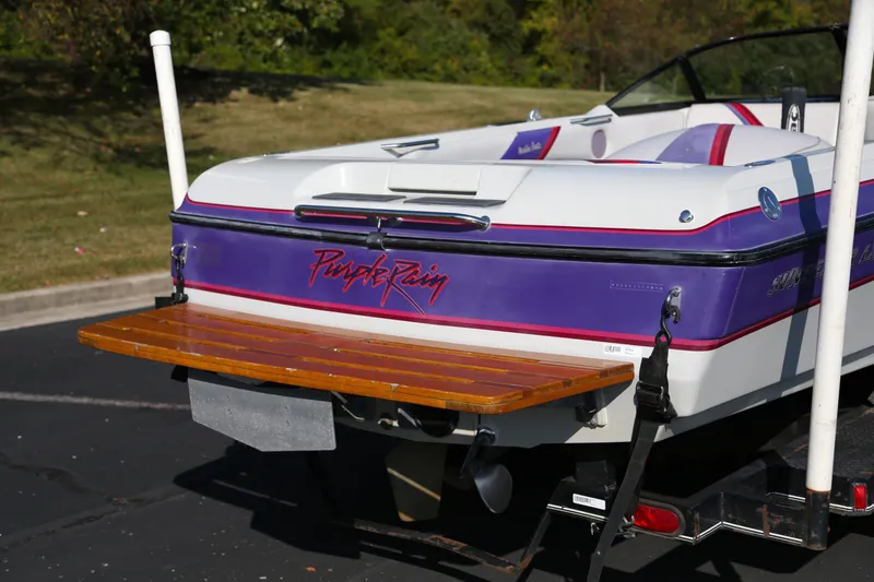 Slide: The Image of 1996 Malibu Sunsetter LX boat interior with white and colorful cushioned seating. - 3