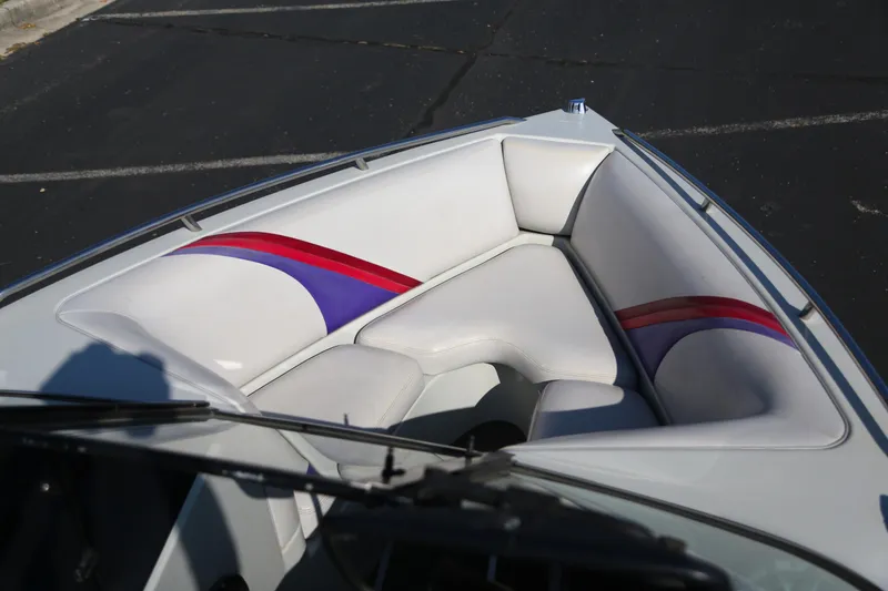 Slide: The Image of 1996 Malibu Sunsetter LX boat interior with white and striped seating. - 4