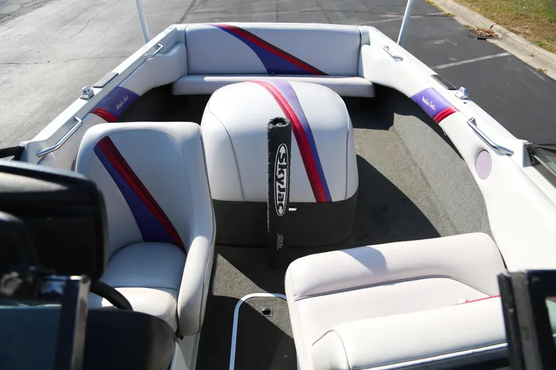 Slide: The Image of 1996 Malibu Sunsetter LX boat interior with white and purple seating. - 5