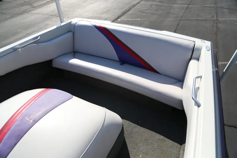 Slide: The Image of Interior of a 1996 Malibu Sunsetter LX boat with white and red-striped seating. - 6