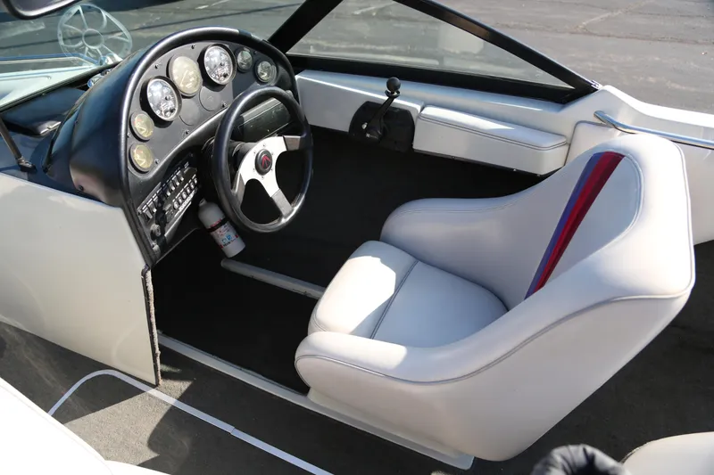Slide: The Image of 1996 Malibu Sunsetter LX boat interior with steering wheel and dashboard gauges. - 7