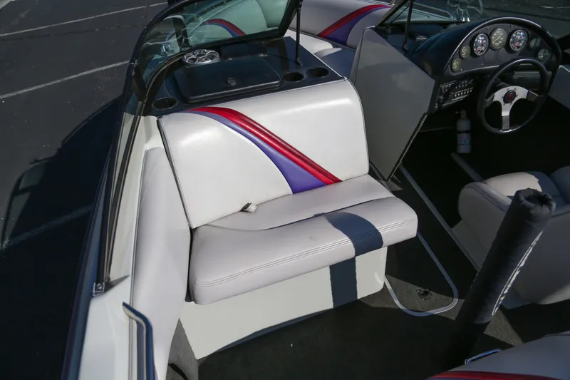 Slide: The Image of 1996 Malibu Sunsetter LX boat interior with white seats and colorful accents. - 8