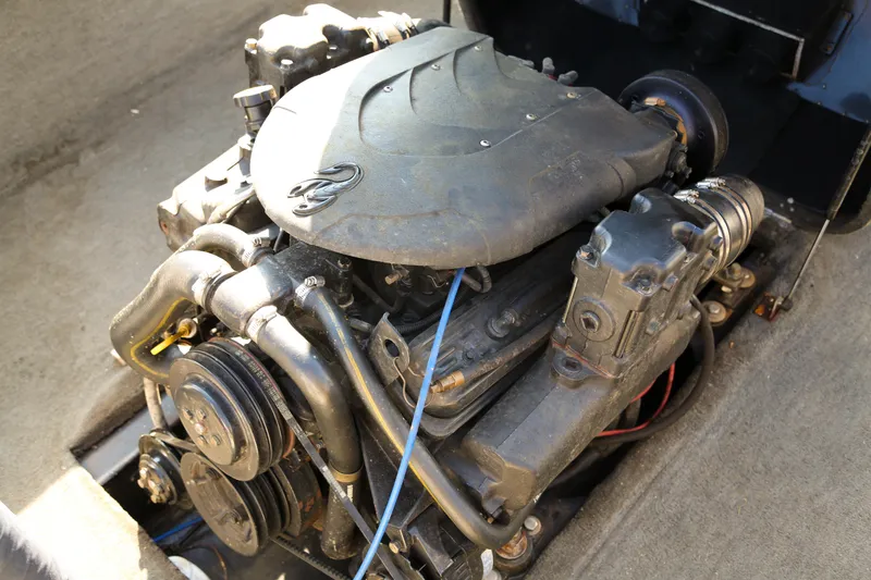 Slide: The Image of Engine of a 1996 Malibu Sunsetter LX boat, showcasing mechanical components. - 9