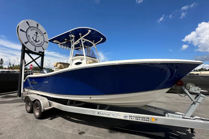 Slide: The Image of 2020 NauticStar 2302 Legacy boat on trailer under clear blue sky. - 0
