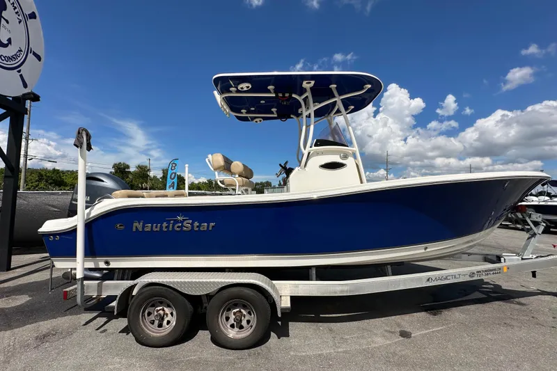 Slide: The Image of 2020 NauticStar 2302 Legacy boat on trailer under blue sky. - 1