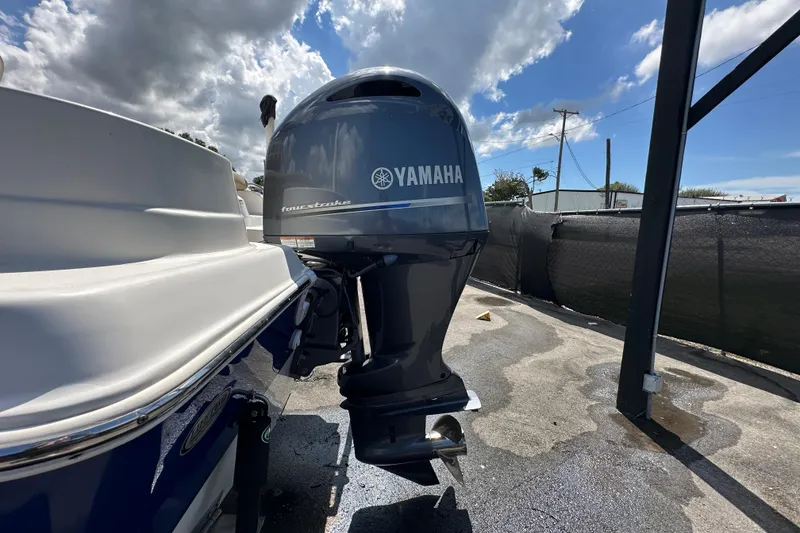 Slide: The Image of 2020 NauticStar 2302 Legacy boat on trailer under cloudy sky. - 10