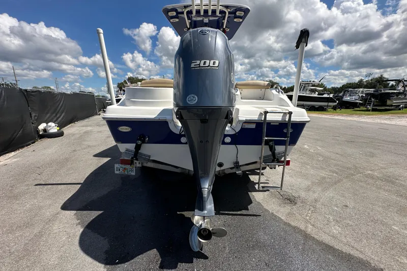 Slide: The Image of 2020 NauticStar 2302 Legacy boat on trailer under cloudy sky at marine dealership. - 11