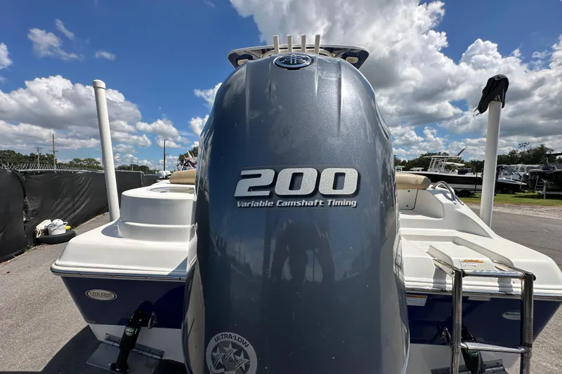 Slide: The Image of 2020 NauticStar 2302 Legacy boat on trailer under clear blue sky. - 12