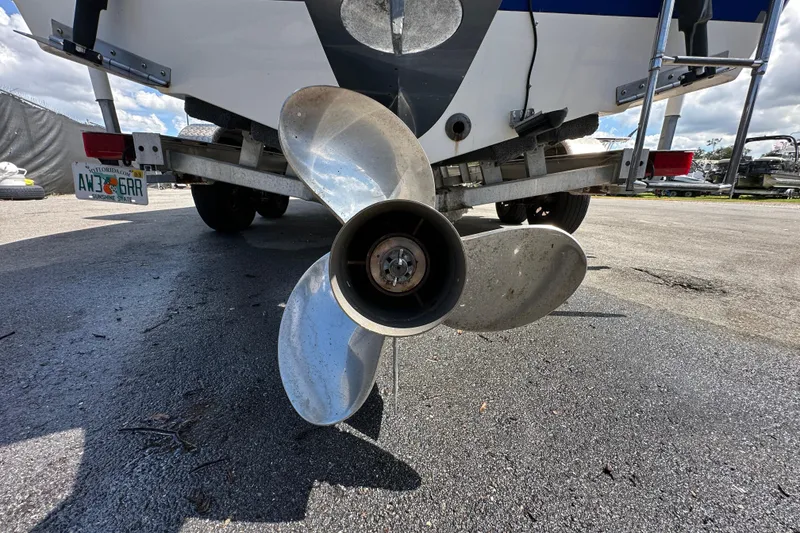 Slide: The Image of 2020 NauticStar 2302 Legacy boat on trailer under clear blue sky. - 13
