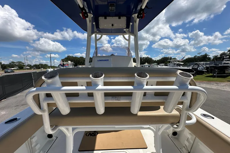 Slide: The Image of 2020 NauticStar 2302 Legacy boat with rod holders and Lowrance equipment under a blue sky. - 18