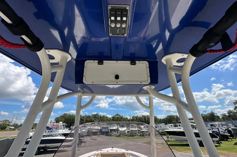 Slide: The Image of 2020 NauticStar 2302 Legacy boat interior with blue canopy and control panel. - 25