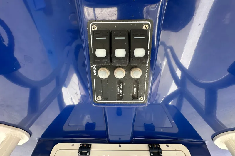 Slide: The Image of Control panel on a 2020 NauticStar 2302 Legacy boat, featuring switches and buttons. - 26