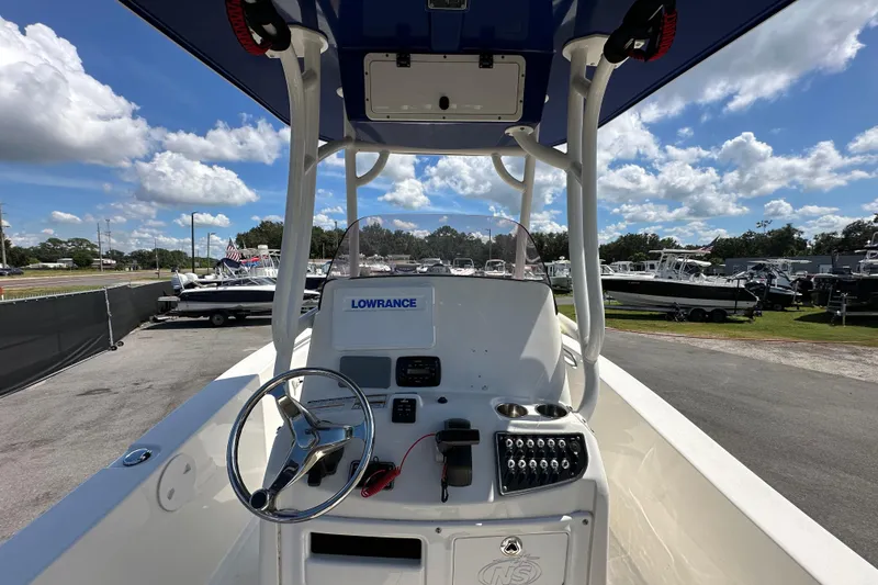 Slide: The Image of 2020 NauticStar 2302 Legacy boat console with steering wheel and Lowrance electronics. - 29