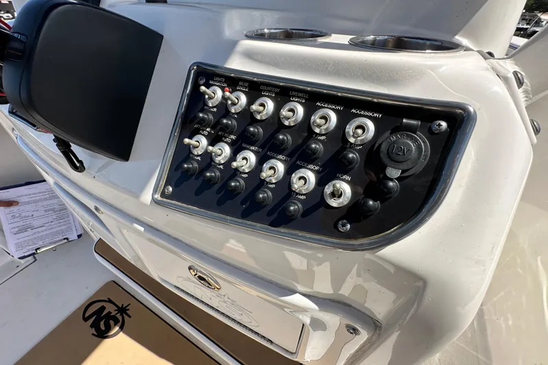 Slide: The Image of Control panel of 2020 NauticStar 2302 Legacy boat with switches and 12V outlet. - 37