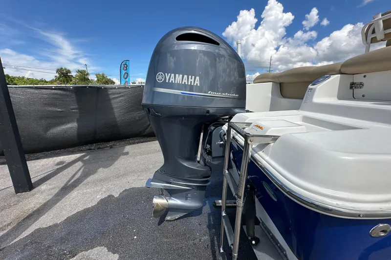 Slide: The Image of 2020 NauticStar 2302 Legacy with Yamaha outboard motor, parked under a clear blue sky. - 4