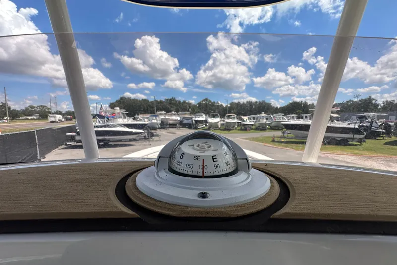 Slide: The Image of Compass view from 2020 NauticStar 2302 Legacy boat, overlooking a marina under a blue sky. - 40