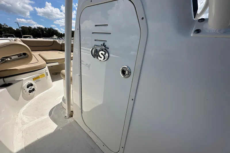 Slide: The Image of 2020 NauticStar 2302 Legacy boat interior with seating and storage compartment. - 42