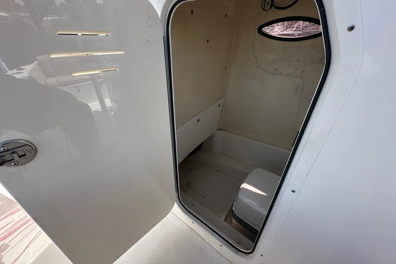 Slide: The Image of 2020 NauticStar 2302 Legacy boat interior cabin with open door. - 43