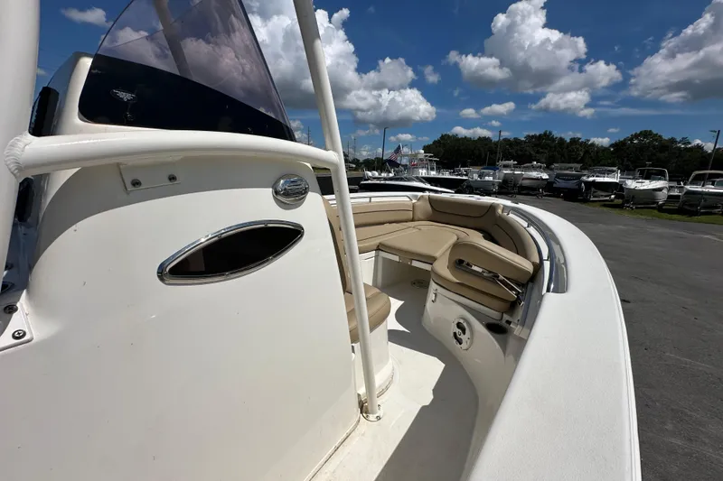 Slide: The Image of 2020 NauticStar 2302 Legacy boat with beige seating under a blue sky. - 45