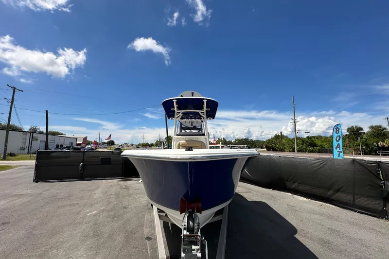 Slide: The Image of 2020 NauticStar 2302 Legacy boat with powerful 200 HP engine, parked outdoors. - 5