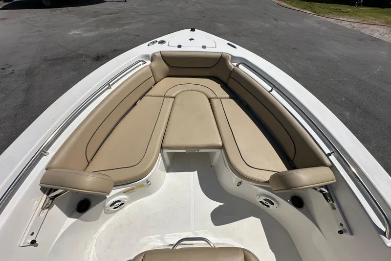 Slide: The Image of 2020 NauticStar 2302 Legacy boat with tan cushioned seating in the bow area. - 51