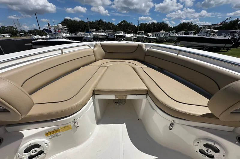 Slide: The Image of 2020 NauticStar 2302 Legacy boat with spacious tan seating under a blue sky. - 52