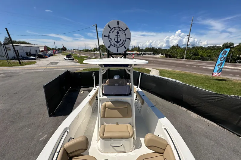 Slide: The Image of 2020 NauticStar 2302 Legacy boat on display at a dealership with sale sign. - 62
