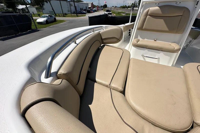 Slide: The Image of 2020 NauticStar 2302 Legacy boat interior with beige cushioned seating. - 65