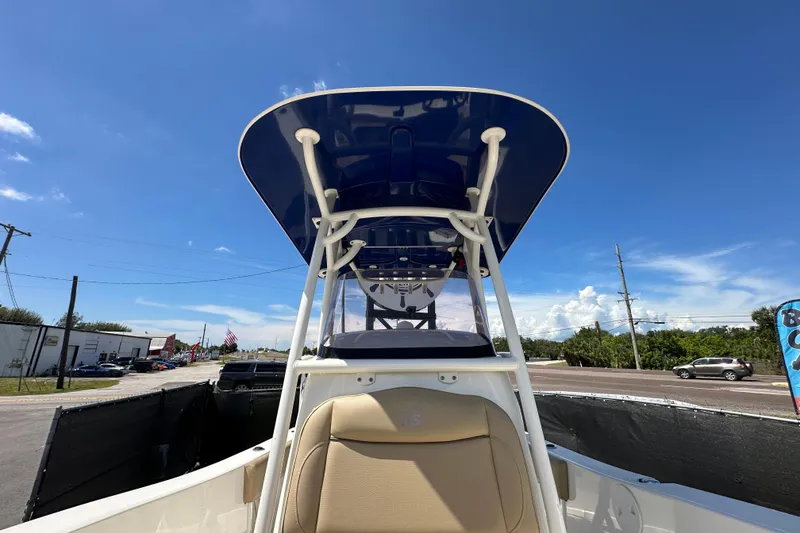 Slide: The Image of 2020 NauticStar 2302 Legacy boat with blue T-top under clear sky. - 68