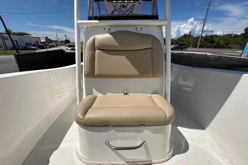 Slide: The Image of 2020 NauticStar 2302 Legacy boat seat with beige upholstery and storage compartment. - 69