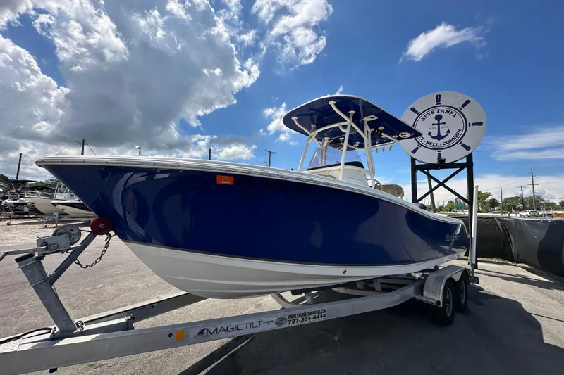 Slide: The Image of Propeller of a 2020 NauticStar 2302 Legacy boat on a trailer, sunny day. - 7