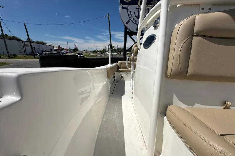 Slide: The Image of 2020 NauticStar 2302 Legacy boat interior with beige seating and white deck. - 70