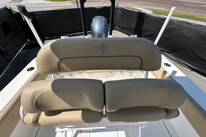 Slide: The Image of 2020 NauticStar 2302 Legacy boat seats with beige upholstery and logo. - 78